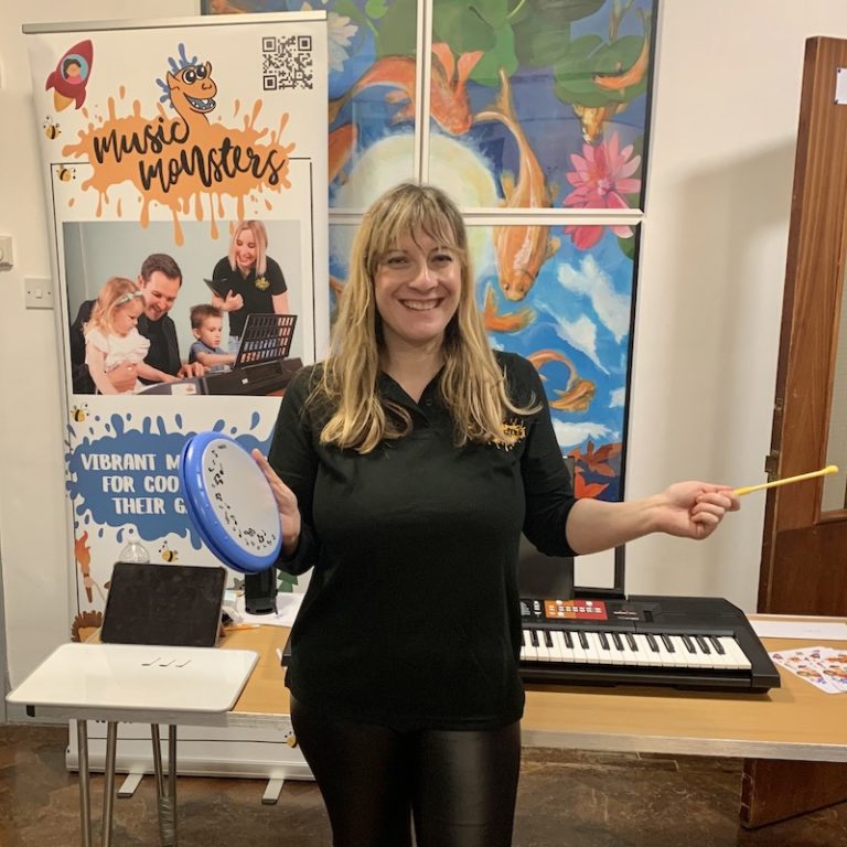 teacher holding tambourine in classroom