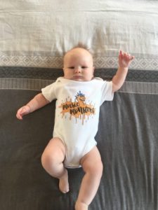 Baby dressed in a Music Monsters baby grow